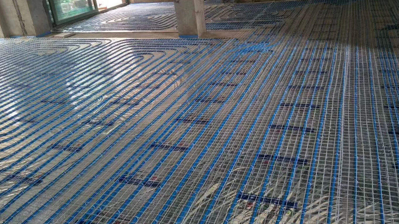 Blue tubing in underfloor yellow holding mat.